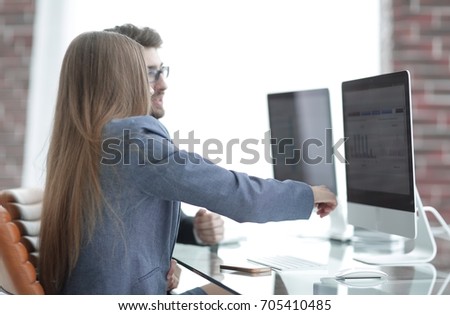 colleagues discussing information on a computer
