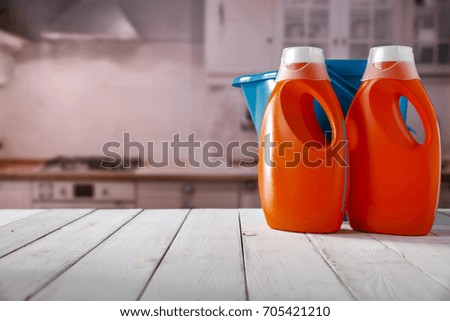 Cleaners on a wooden table in a sunny kitchen