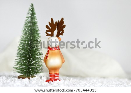 Christmas card with miniature Christmas tree and reindeer decoration. Christmas and New Year background concept with copy space. Festive holiday composition	