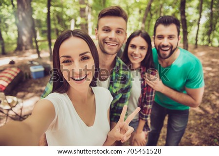 Selfie time1 Close up of four cheerful  friends in the spring nice wood, embracing, posing for a selfie shot, that attractive brunette lady is taking
