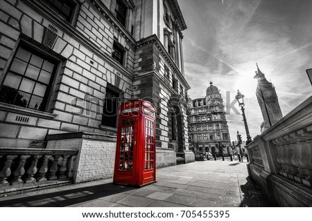 Big ben on the background and red telephone booth in London at sunrise. Black and white picture with red telephone box.