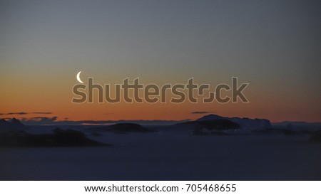 Silhoutte and view of moon at Antarctica. This picture was taken at Larsemann hills , Antarctica on 05-29-2017.