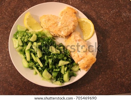 Heart Shaped Salmon Fillets With Green Organic Homegrown Vegetable Salad Sprinkled With Lemon
