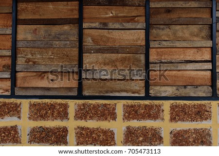 Old wooden plank and brick pattern. Antique rough and rustic fence of rural house.