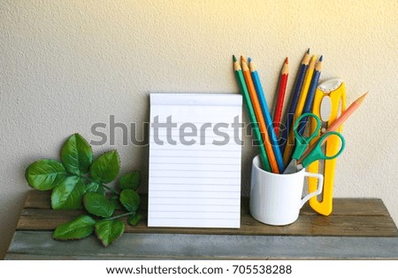 Notepad with pencil colorful on wood board background. using wallpaper or background for education, business photo. Take note of the product for book with paper and concept or copy space.