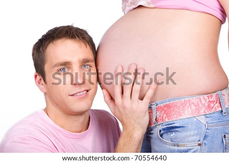 Image of happy man kissing pregnant belly of his wife