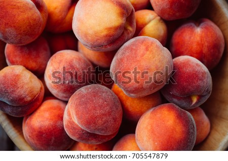 A group of ripe peaches in a bowl Royalty-Free Stock Photo #705547879