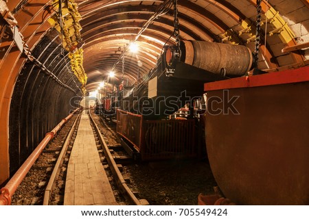 Empty conveyor belt in underground coal mine. Crisis in the mining industry Royalty-Free Stock Photo #705549424
