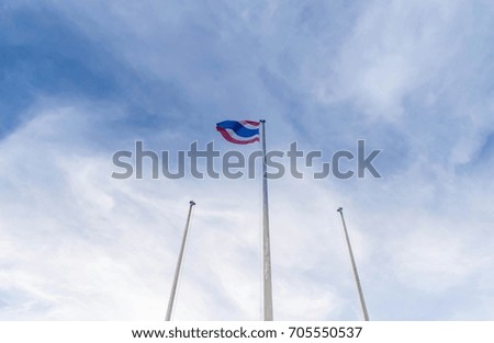 waving Thai flag of Thailand with could and blue sky 