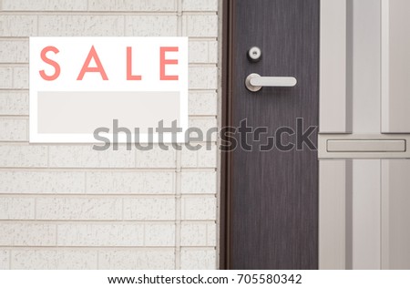 Sale Real Estate Sign in Front of house
