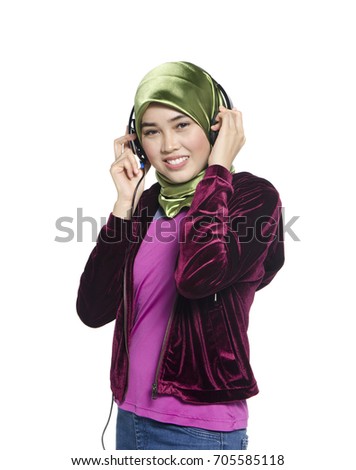 Studio shoot, beautiful active young lady with hijab listening to music isolated on white background. ideal for music and entertainment concept