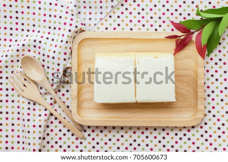 Top view butter milk cake in wooden dish 