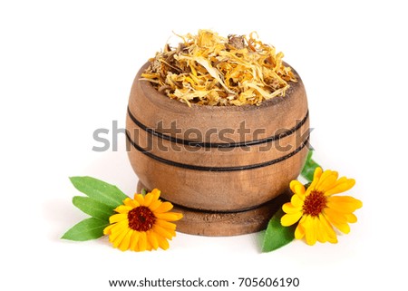 Fresh and dried calendula flowers in a wooden bowl isolated on white background. Marigold