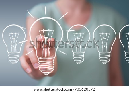 Businesswoman on blurred background touching and holding a sketch lightbulb with a pen