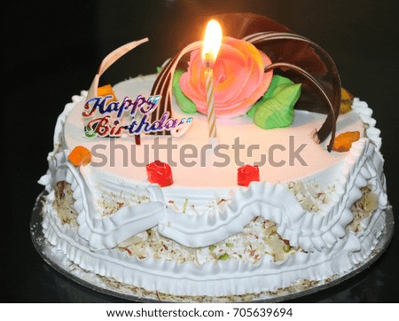  close-up view of Birthday cake with lite  candles, black background