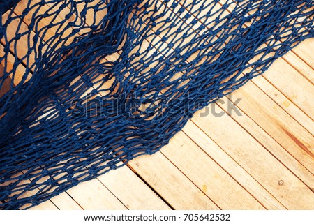 Blue mesh on wooden floor for background.