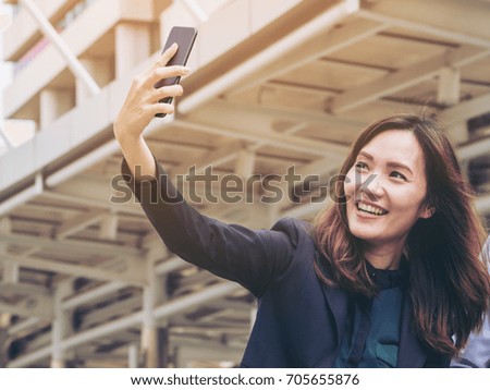 Business woman enjoy using smartphone in the city.
