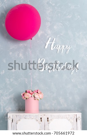 Birthday card. Postcard in pastel colors with words Happy Birthday. One big pink balloon and flower box.