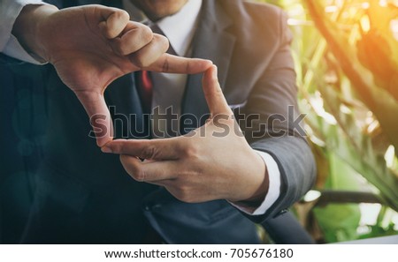 Businessman making a frame with his hands