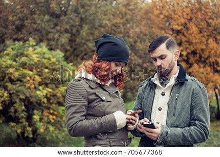Young couple dating . Problem of people's communication. INternet addiction . a girl and a man do not pay attention to each other, and they look at the Internet