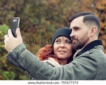 Young couple kissing and making selfie. Problem of people's communication. smartfon addiction