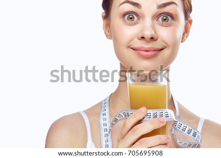 Vitamin D, freshly squeezed juice, woman with natural make-up, measuring tape                               