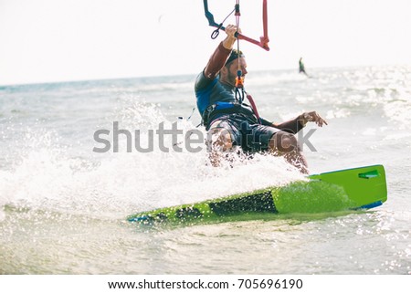 Kitesurfing, Kiteboarding action photos, man among waves quickly goes