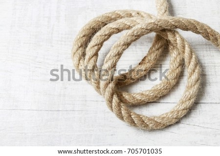 Ship rope isolated on white wooden background.