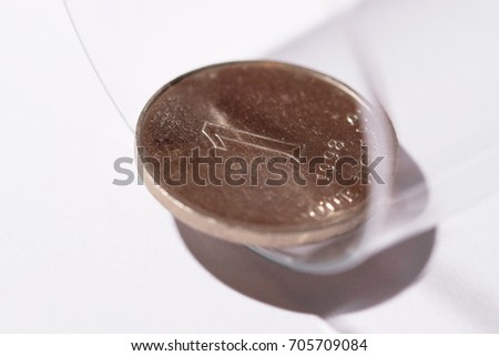 Coin in glass