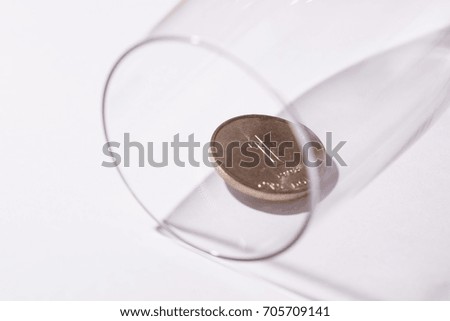 Coin in glass