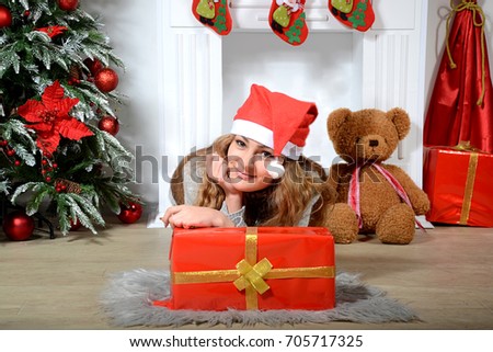 Happy young  girl with a teddy bear near a decorated Christmas tree.New Year
