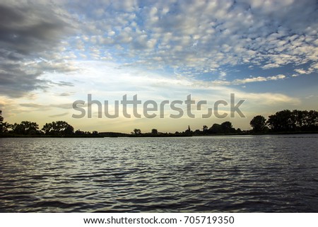 Clouds at sunset and light reflection in water