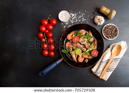 Bbq grilled shrimps on fried pan serving with cherry tomato, basil, leek and baked garlic. Barbecue seafood concept. Healthy diet food. Top view. View from above. copy space