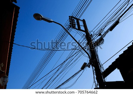 street light with messy electrical wires and clear sky