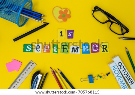 September 15th. Day 15 of month, Back to school concept. Calendar on teacher or student workplace background with school supplies on yellow table. Autumn time