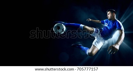 Soccer player in action on a dark background