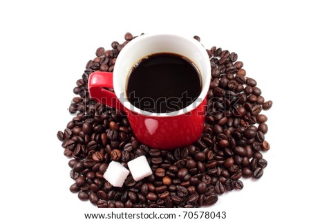 Red mug of coffee with roasted coffee beans and sugar lumps