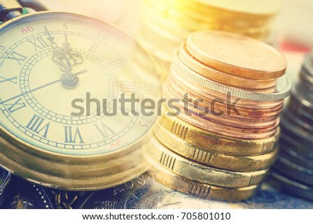 Time is money, business finance concept : Many coins and vintage brass pocket watch, idea of time which is a valuable commodity or resource and it's better to do work or things as quickly as possible. Royalty-Free Stock Photo #705801010
