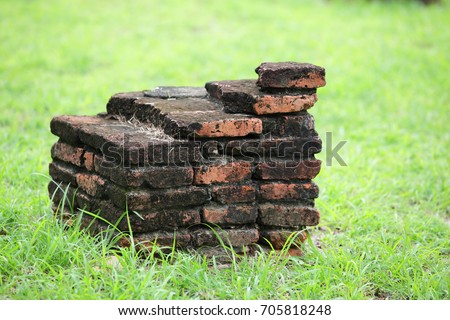 ancient brick with green grass background.
