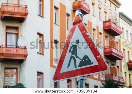 red building site sign in a street