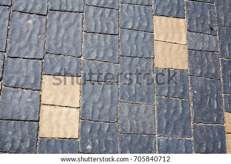 Stone pavement texture. Granite cobblestoned pavement background. Abstract background of old cobblestone pavement close-up. Seamless texture. Perfect tiled on all sides