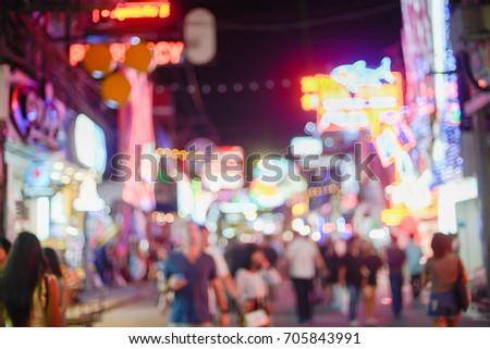  picture in motion blur of people crossing a city walking through the Walking Street in Pattaya,Thailand. Its a tourist attraction primarily for night life