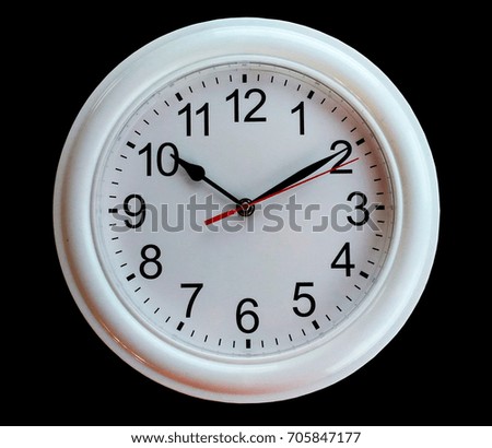 round white wall clock isolated on black background