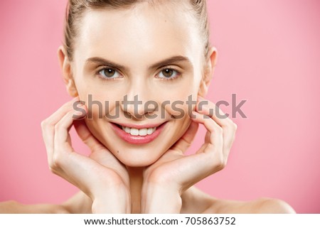 Beauty Spa Concept - Caucasian Woman with perfect face skin Portrait. Beautiful Brunette Spa Girl showing empty copy space. Isolated on pink studio background. Proposing a product.