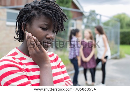 Sad Teenage Girl Feeling Left Out By Friends Royalty-Free Stock Photo #705868534