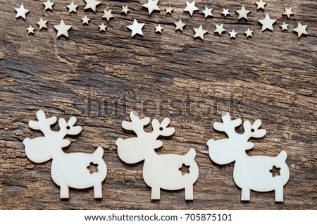 Christmas holidays background. Reindeer and star on wooden table with copy space. 