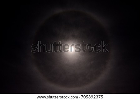 Photo Picture Full moon in a cloudy sky with halo