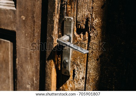 old damaged door with metallic handle
