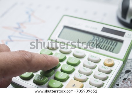  Close-up photo of a businessman's hand  counting on calculator in office,Financial data analyzing,Business concept