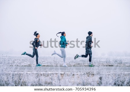 Photo of athlete people running outdoors in the winter.